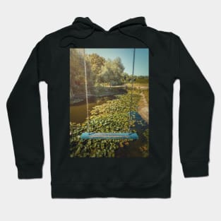 swing hanging over a waterlilies pond Hoodie